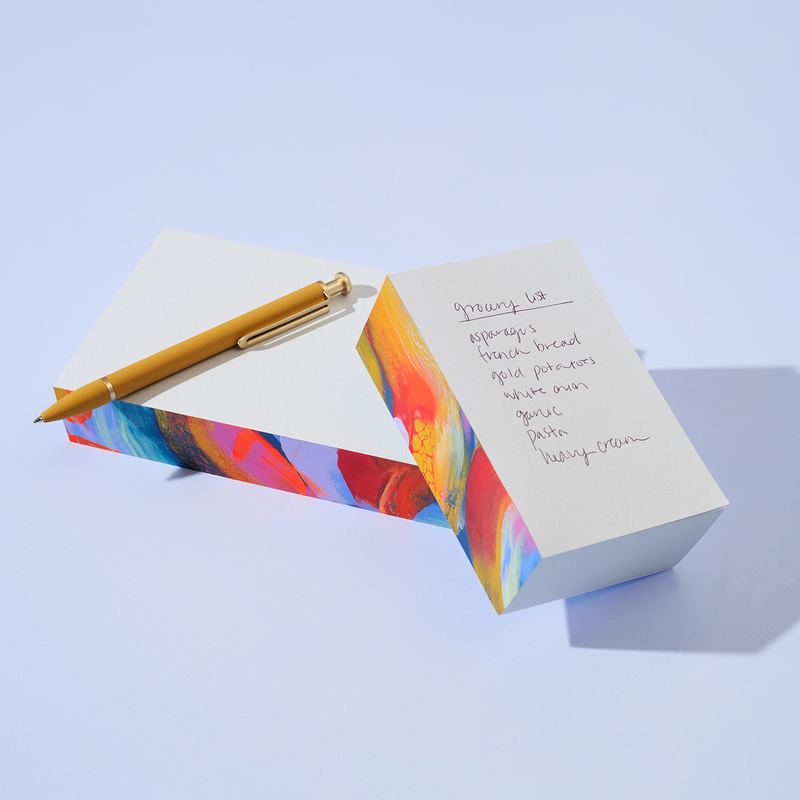 Small Moglea Supernova Swirl Pad notepad with vibrant swirl cover and lined pages for note-taking and journaling.